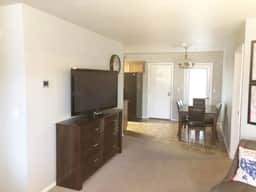 The 50" flatscreen TV with swivel base is visible from the living or dining area.