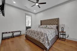 Master bedroom with king bed, TV, attached master bathroom and walk-in closet.