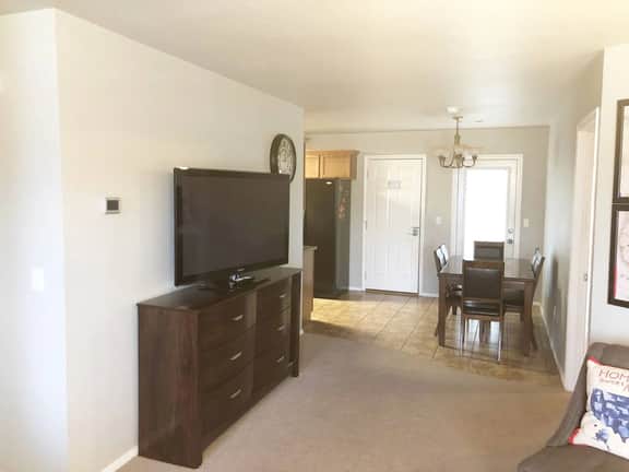 The 50" flatscreen TV with swivel base is visible from the living or dining area.