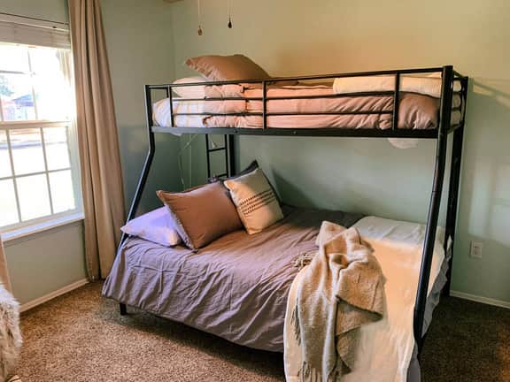 Full size bottom bunk, twin size top bunk, and twin size trundle underneath. Sun blocking curtains and pull down blinds.